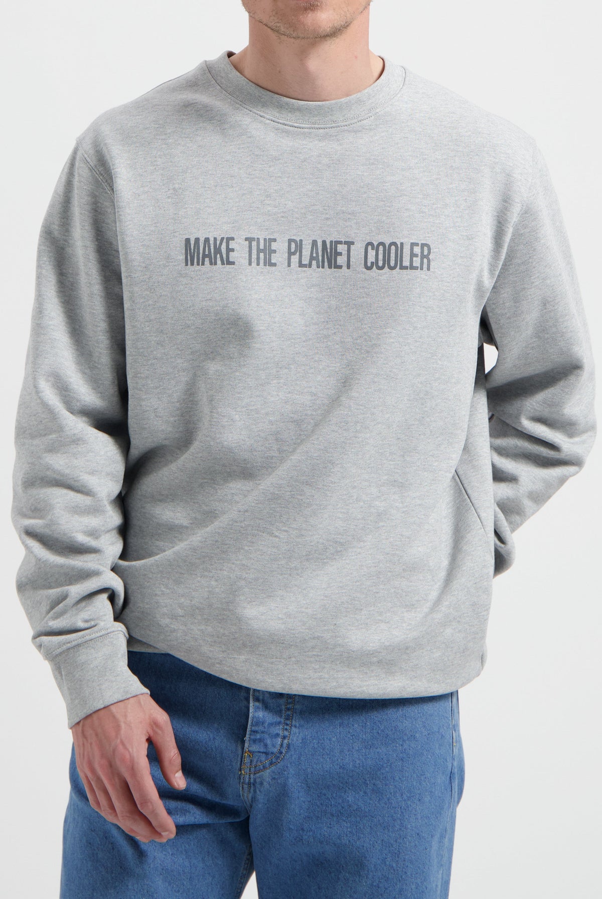 Sustainable MUD Jeans in blue denim paired with a gray ethical sweatshirt with "Make the Planet Cooler" text.