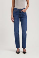 Stylish blue straight-leg jeans paired with a light gray sleeveless top and black pointed-toe heels.